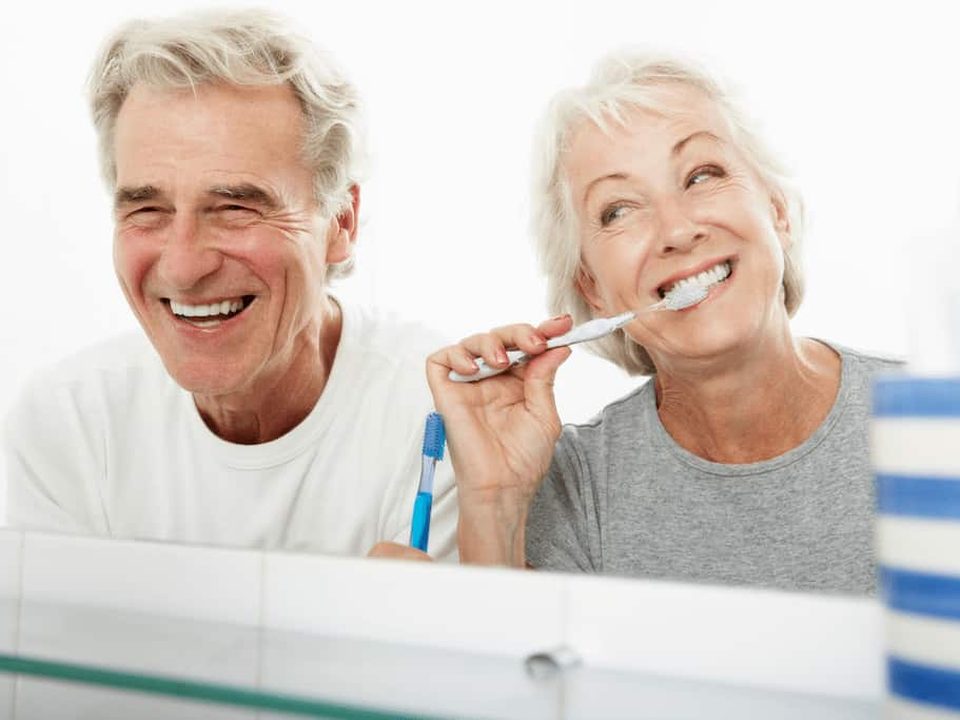 Couple brushing their teeth, daily gum care